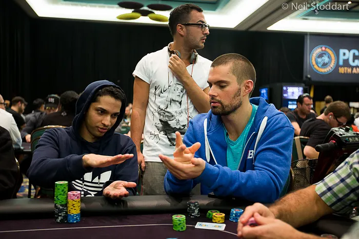 Mohsin Charania (left) and Doc Sands (right) play "Rock, Paper, Scissors"