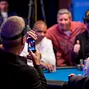 Bobby Baldwin takes a photo of Phil Ivey, Mike Sexton and Phil Hellmuth on his phone.