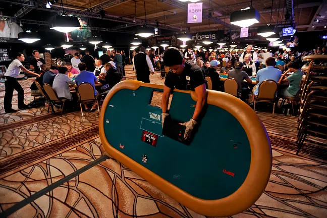 Rio employee Myrna Valdivia breaks down a poker table as the tournament area shrinks on Day 5.