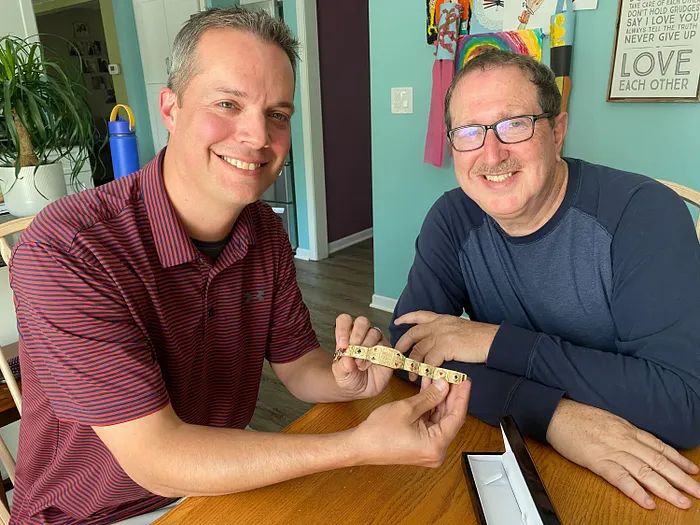 Michigan bracelet winner Todd Estes with Norman Chad