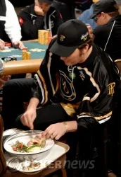 Phil Hellmuth che mangia (cos'altro) pesce per cena durante il gioco la scorsa notte