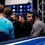 Phil Ivey chats with Daniel Negreanu while waiting to retake his seat