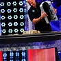 Guy Laliberté dumps his one million dollar entry onto the table.