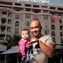 Imed Ben Mahmoud  holds his daughter and his new WSOPE bracelet 