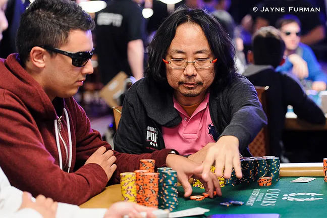 Dong Guo won a massive pot with aces.