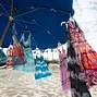 Some Caribbean-style dresses for sale on the beach