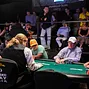 Players at the final table in Event 28 and their supporters on the rail