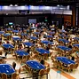 Players crowd around the High Roller final table