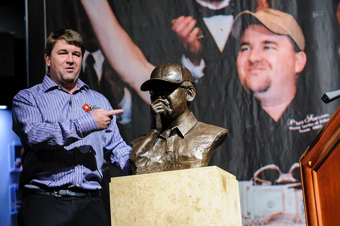 Chris Moneymaker posing with the commemorative bust