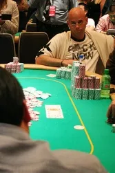 Guy Laliberte stares down Paul Lee after moving all in