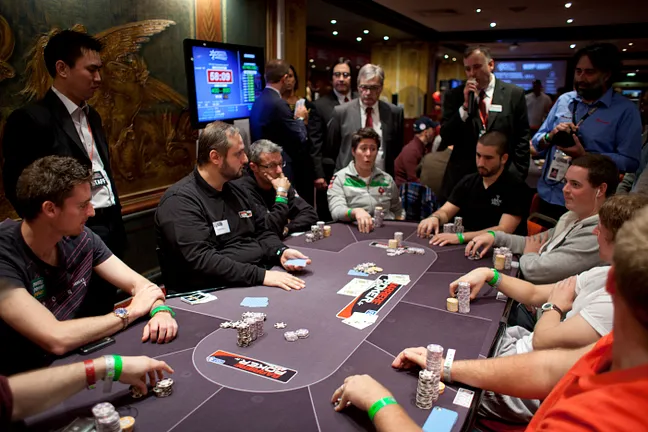 Eoghan Odea (seated left) takes a bad beat on his pocket aces to bust the bubble.