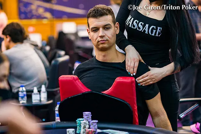 Poker player getting a massage at the table