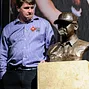 Chris Moneymaker posing with the commemorative bust