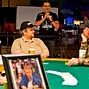 Poker Pro Chad Brown pays tribute to Dr. Jerry Buss. A portrait of Buss on the table in foreground.