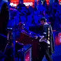Phil Hellmuth is greeted by a fan as he makes his exit from the WSOP Main Event 2011