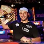 Michael Mizrachi holds aloft the David "Chip" Reese Trophy after winning his second $50,000 Poker Players Championship in 2012