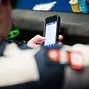 Jonathan Duhamel catches up with the action from the PokerNews app