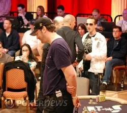 A dejected Phil Hellmuth (foreground), moments after his stunning loss to Bertrand Grospellier (background, right)