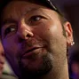 Daniel Negreanu relays the action to people on rail.