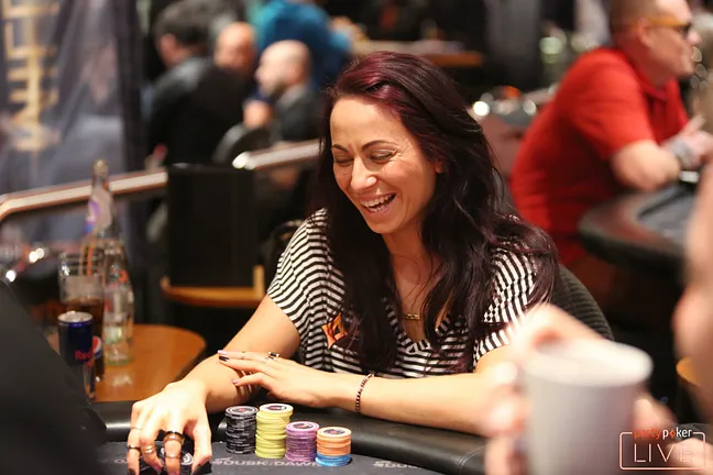 Natalia Breviglieri shares a joke at the felt during the partypokerLIVE MILLIONS Main Event