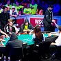 Phil Hellmuth  fist bumps" JC Tran as he visits the secondary feature table.