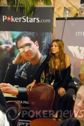 A spectator sits in front of a PokerStars banner featuring Luca Pagano
