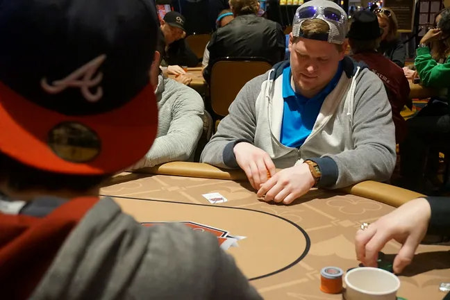 Justin Smith (right) sitting across from David Kim, who just busted him with a straight flush
