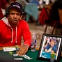 Poker Pro Phil Ivey is seated at the table with the honarary photo and chip stack for Dr. Jerry Buss.