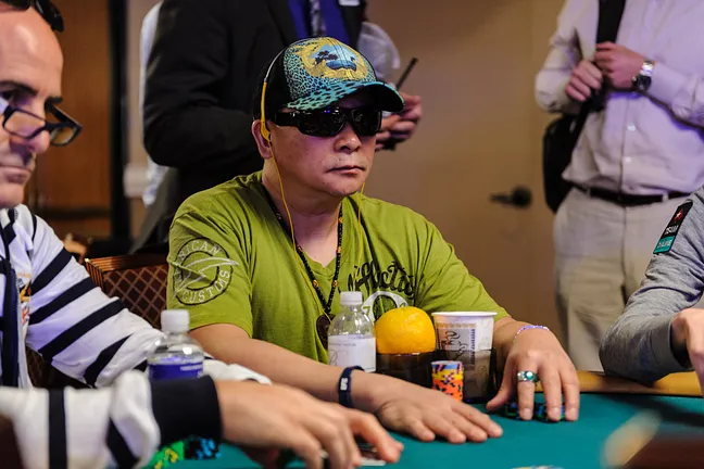 Johnny Chan Seated at a Stacked Table
