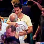 Antonio Esfandiari shares a ahug with his father, Bejan, after winning the Big One For One Drop Tournament.